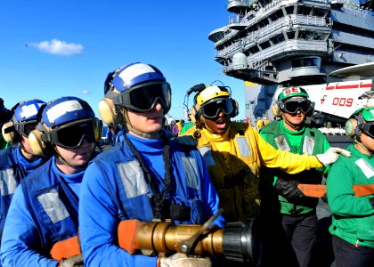US Navy 101016-N-3374C-004 A Sailor aboard the aircraft carrier USS George H.W. Bush (CVN 77) gives instructions to the fire hose team during a mas