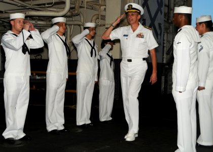 US Navy 101014-N-0120A-001 Rear Adm. Ron Horton, commander of Logistics Group Western Pacific, passes through sideboys aboard the forward-deployed