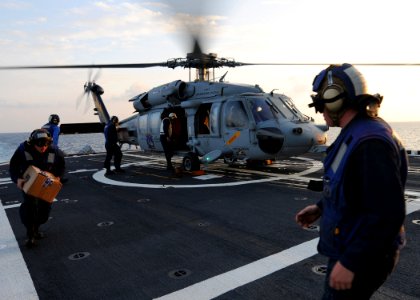 US Navy 101018-N-5016P-067 Sailors aboard the guided-missile cruiser USS Cape St. George (CG 71) collect the crew's mail from an SH-60S Sea Hawk he photo