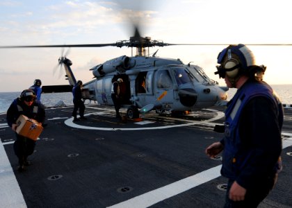 US Navy 101018-N-5016P-067 Sailors aboard the guided-missile cruiser USS Cape St. George (CG 71) collect the crew's mail from an SH-60S Sea Hawk he