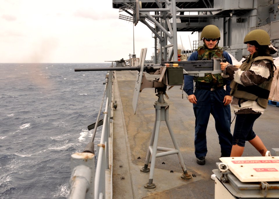 US Navy 101010-N-5483N-023 Lisa Boyer, mother of Information Systems Technician 3rd Class Alec Hanna, fires a .50-caliber Browning machine gun