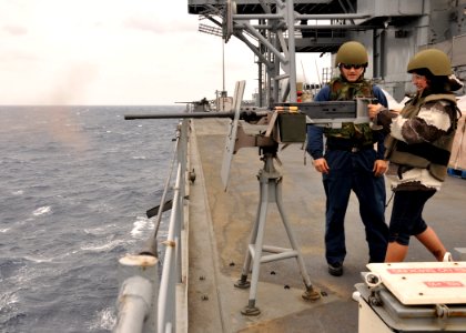 US Navy 101010-N-5483N-023 Lisa Boyer, mother of Information Systems Technician 3rd Class Alec Hanna, fires a .50-caliber Browning machine gun photo
