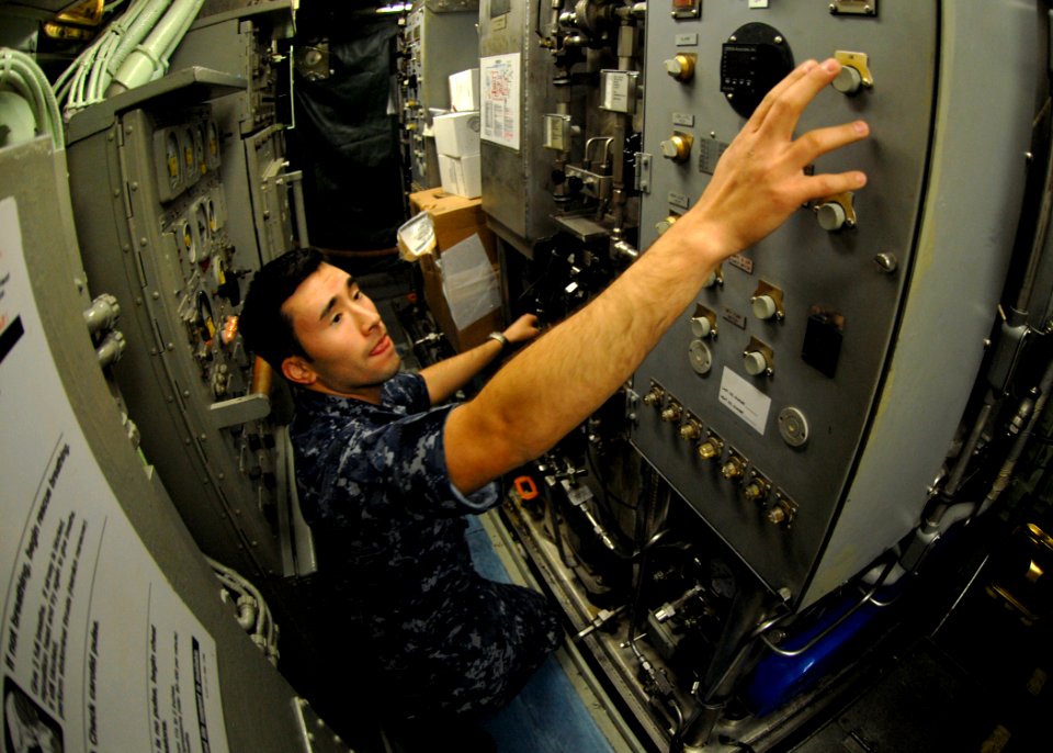 US Navy 101013-N-7705S-020 Machinist's Mate 1st Class Alberto Lezama, from New York, switches the number one carbon dioxide scrubber into recircula