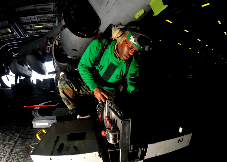 US Navy 101013-N-7103C-060 Aviation Structural Mechanic 2nd Class Richard Jeanbaptiste, from Flushing, N.Y., conducts maintenance on a EA-6B Prowle