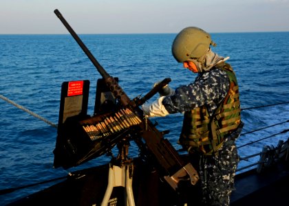 US Navy 111125-N-VH839-001 Gunner's Mate 2nd Class Jeremy Bennett mans a mounted .50-caliber machine gun aboard the Arleigh Burke-class guided-miss