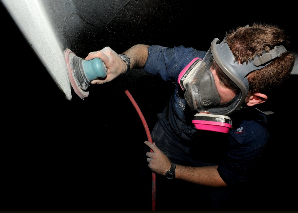 US Navy 101011-N-6427M-104 viation Machinist's Mate 3rd Class Jonathon Holtzendorf, from Aiken, S.C., performs corrosion maintenance on an F-A-18F