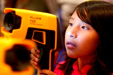 US Navy 101013-N-8863V-460 A fourth grade student from Arlanza Elementary School looks through a Navy thermal imager during the 11th annual Science