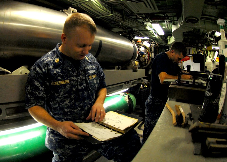 US Navy 101013-N-7705S-010 Chief Machinist's Mate Tim Mecklenberg, from Killeen, Texas, verifies the maintenance procedures for torpedo room equipm