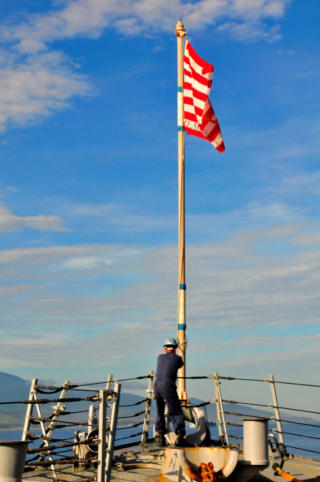 US Navy 111127-N-ER662-301 A Sailor aboard the Arleigh Burke-class guided-missile destroyer USS Stethem (DDG 63) raises the Navy jack while underwa