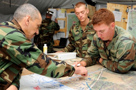 US Navy 101013-N-3013W-177 Reserve Force Master Chief Ronney Wright speaks with Builder 1st Class Garrett Ray, assigned to Naval Mobile Constructio