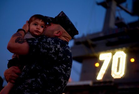 US Navy 111130-N-DR144-285 Aviation Boatswain's Mate Airman Jarren Enriquez says goodbye to his family before the Nimitz-class aircraft carrier USS