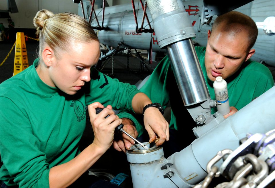 US Navy 101017-N-6632S-014 Aviation Structural Mechanic 3rd Class Katie J. Heninger, left, and Aviation Structural Mechanic 2nd Class Christopher H