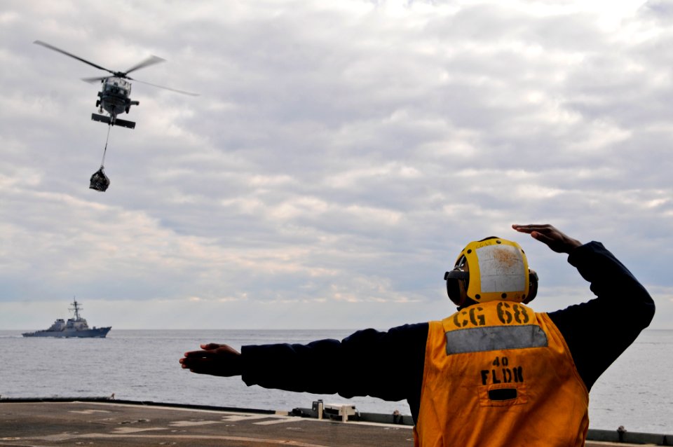 US Navy 111129-N-YM590-201 Boatswain's Mate Seaman Apprentice Jabari Hosten directs an SH-60B Sea Hawk helicopter, assigned to Helicopter Anti-Subm