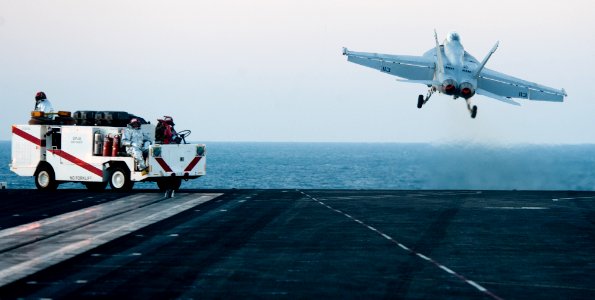 US Navy 111123-N-OY799-206 Sailors from crash and salvage stand watch on the bow as an F-A-18F Super Hornet from the Black Aces of Strike Fighter S