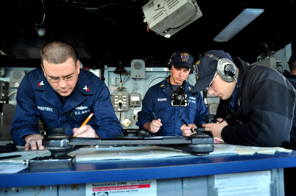 US Navy 111128-N-YX169-263 Sailors figure the course of the amphibious transport dock ship USS Ponce (LPD 15) as the ship gets underway from Naval