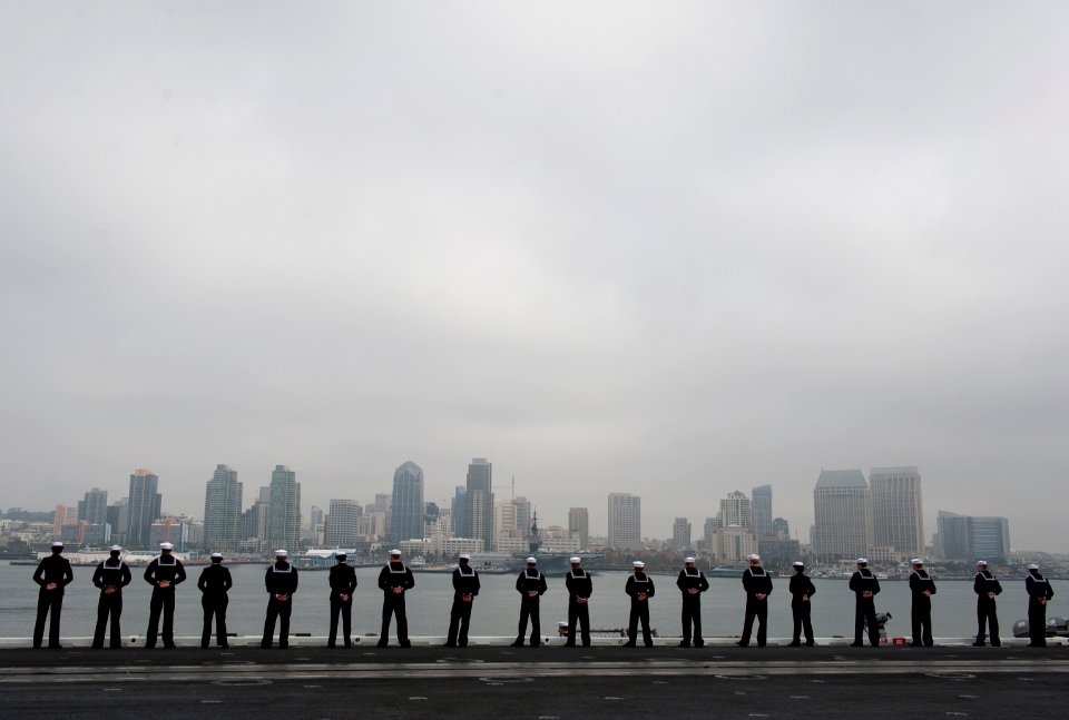 US Navy 111130-N-DR144-982 Sailors man the rails as Nimitz-class aircraft carrier USS Carl Vinson (CVN 70) departs Naval Air Station North Island f