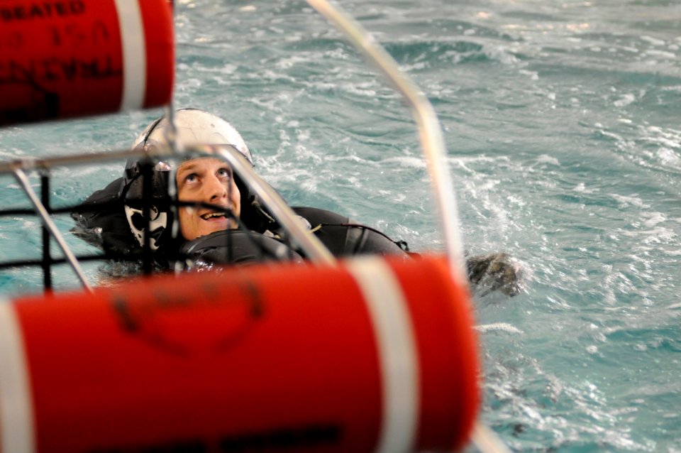 US Navy 101013-N-5787K-054 Aircrew Survival Equipmentman 1st Class James Kirlin waits in full gear for the hoist to be lowered to him during the Av