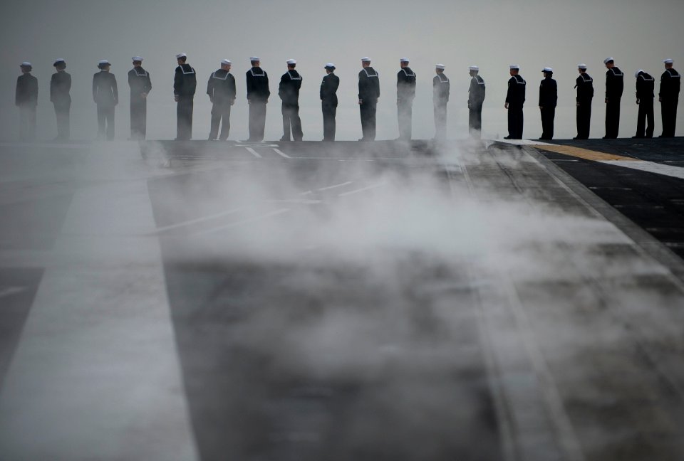 US Navy 111130-N-DR144-561 Sailors man the rails as the Nimitz-class aircraft carrier USS Carl Vinson (CVN 70) prepares to depart Naval Air Station