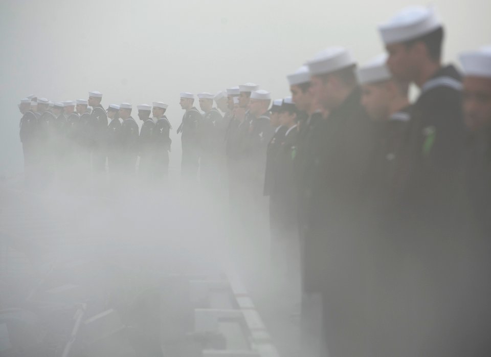 US Navy 111130-N-DR144-630 Sailors man the rails as the Nimitz-class aircraft carrier USS Carl Vinson (CVN 70) prepares to depart Naval Air Station