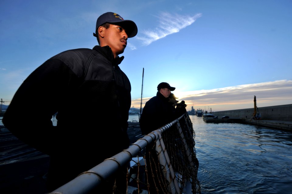US Navy 111126-N-YZ751-015 Interior Communications Electrician Fireman Taofia M. Garcia mans the rails of the guided-missile destroyer USS Truxtun