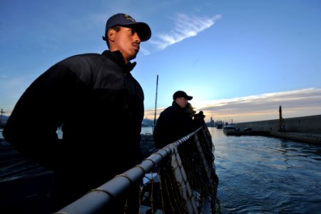 US Navy 111126-N-YZ751-015 Interior Communications Electrician Fireman Taofia M. Garcia mans the rails of the guided-missile destroyer USS Truxtun photo