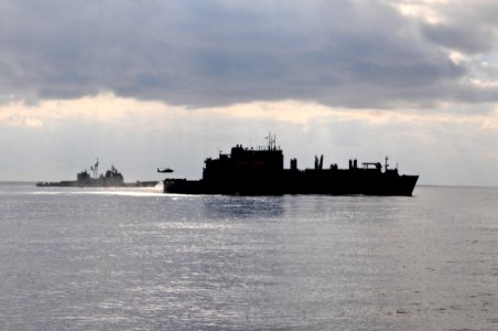 US Navy 111129-N-YM590-075 The Military Sealift Command dry cargo and ammunition ship USNS Sacagawea (T-AKE 2), right, performs a vertical replenis