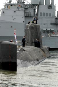 US Navy 111128-N-NK458-054 ailors aboard the Royal Navy submarine HMS Astute (S119) stand in formation topside as the ship is maneuvered into posit