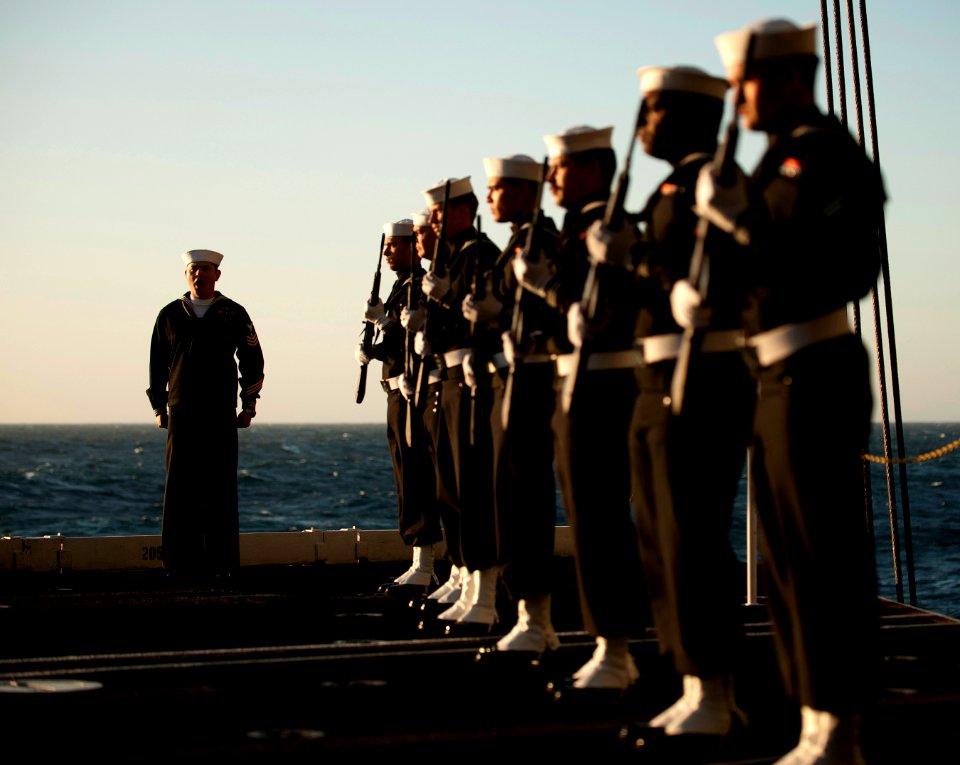 US Navy 111201-N-DR144-501 Gunner's Mate 1st Class David Hurtado commands the rifle detail during a burial at sea ceremony for 20 former service me