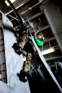 US Navy 111201-N-OY799-067 Aviation Machinist's Mate 2nd Class Huytuan Nguyen, from San Diego, works on the tail rotor of an MH-60S Sea Hawk helico