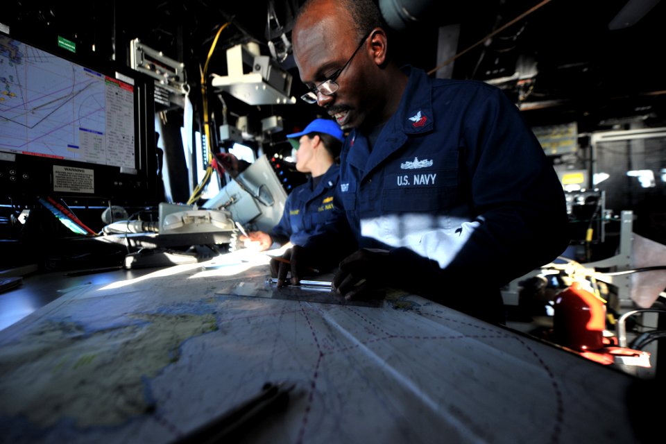 US Navy 111126-N-YZ751-059 Quartermaster 1st Class Kevin A. Wright measures distances on a chart aboard the guided-missile destroyer USS Truxtun (D