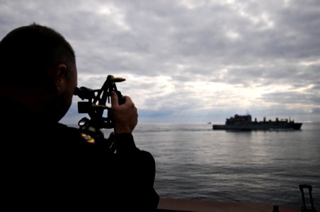 US Navy 111129-N-YM590-210 Chief Quartermaster William Muthig uses a stadimeter aboard the guided-missile cruiser USS Anzio (CG 68) to measure the photo