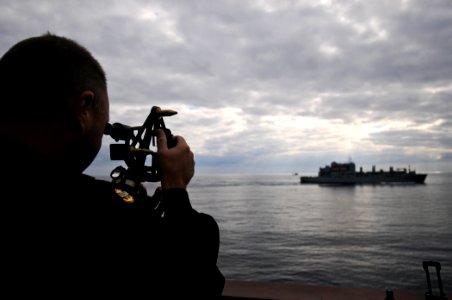 US Navy 111129-N-YM590-210 Chief Quartermaster William Muthig uses a stadimeter aboard the guided-missile cruiser USS Anzio (CG 68) to measure the