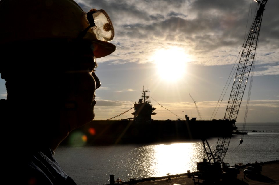 US Navy 111128-N-YX169-042 Boatswain's Mate 3rd Class Michael Mello watches line handlers on the pier untie the amphibious transport dock ship USS