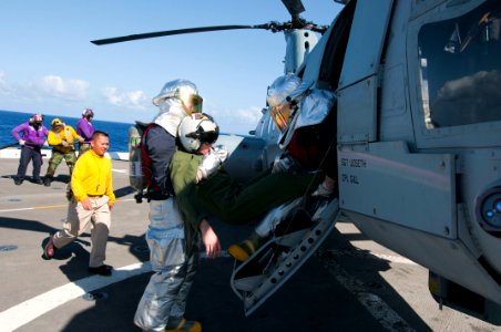 US Navy 111129-N-PB383-815 Damage Controlman Fireman Steven Spernyak and Damage Controlman 3rd Class Taylor Knight carry a simulated casualty durin