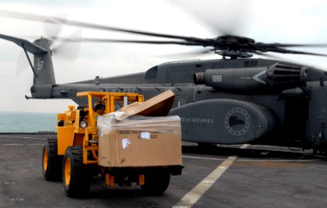 US Navy 111130-N-GH121-282 oatswain's Mate 3rd Class Ronnie Guerra operates a forklift to unload supplies from a MH-53E helicopter from Helicopter