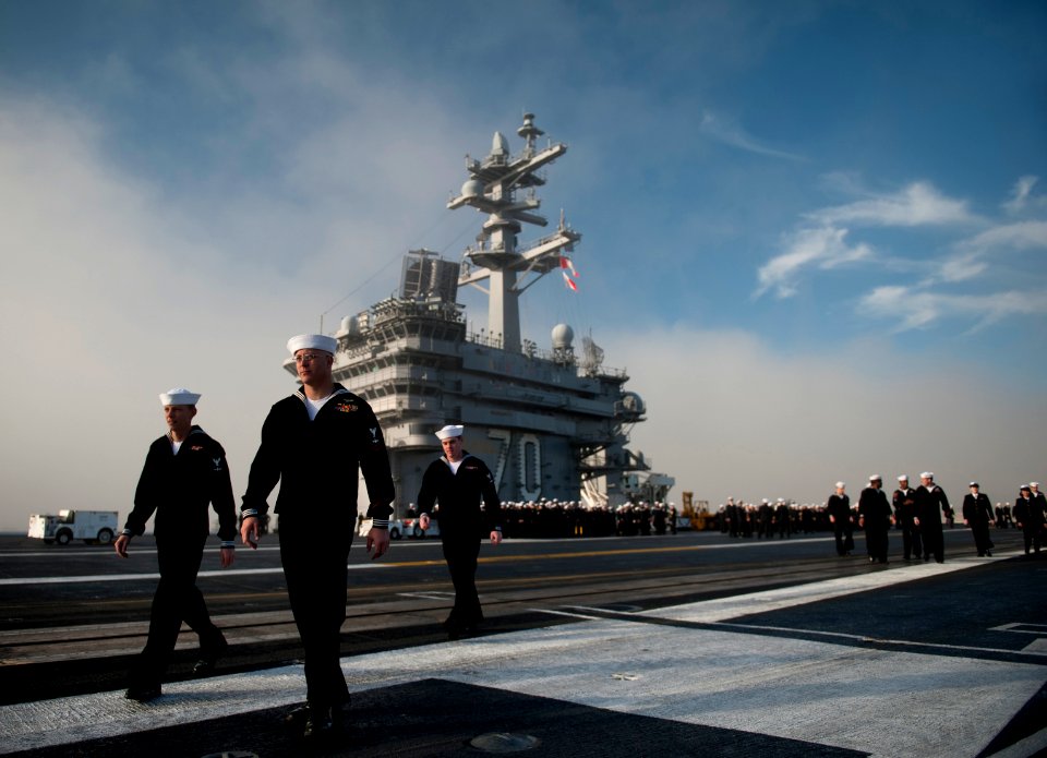 US Navy 111130-N-DR144-349 Sailors man the rails as the Nimitz-class aircraft carrier USS Carl Vinson (CVN 70) prepares to depart Naval Air Station