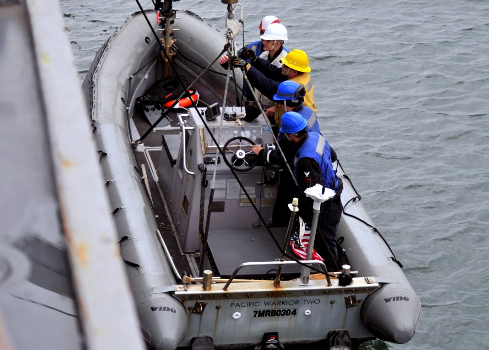 US Navy 111130-N-ZF681-232 Sailors aboard the guided-missile destroyer USS Halsey (DDG 97) are lowered into the ocean in a rigid hull inflatable