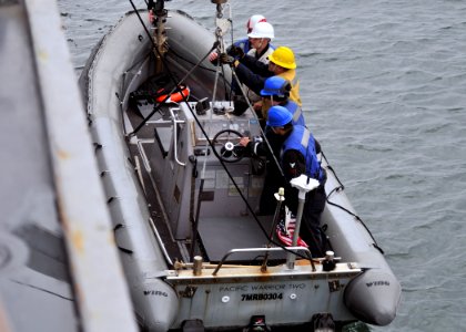 US Navy 111130-N-ZF681-232 Sailors aboard the guided-missile destroyer USS Halsey (DDG 97) are lowered into the ocean in a rigid hull inflatable photo