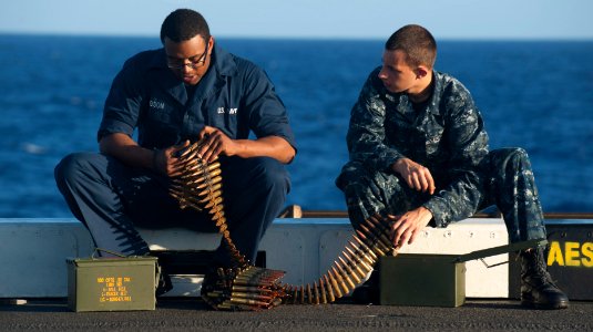 US Navy 111129-N-PB383-232 Ship's Serviceman Seaman Lionel Gibson and Yeoman Seaman Brian Johnson count rounds for a .50-caliber machine gun during