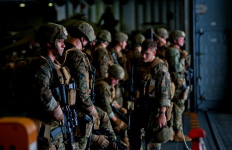 US Navy 111202-N-DX615-015 Marine Sgt. Alex Sanchez, left, assigned to the 11th Marine Expeditionary Unit (11th MEU), looks out at the ocean from t