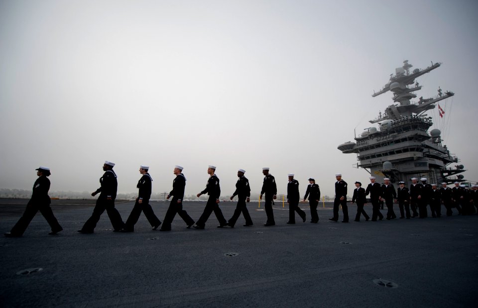 US Navy 111130-N-DR144-376 ailors man the rails as the Nimitz-class aircraft carrier USS Carl Vinson (CVN 70) prepares to depart Naval Air Station