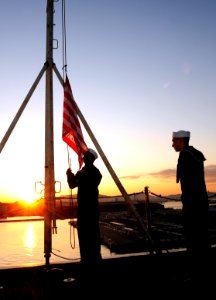 US Navy 111129-N-QL471-022 Aviation Boatswain's Mate (Handling) Airman Jason Kalange and Air-Traffic Controller Airman Mattew M. Huynh raise the Un