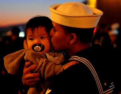 US Navy 111130-N-RG587-076 A Sailor kisses his son goodbye before the Nimitz-class aircraft carrier USS Carl Vinson (CVN 70) departs Naval Air Stat