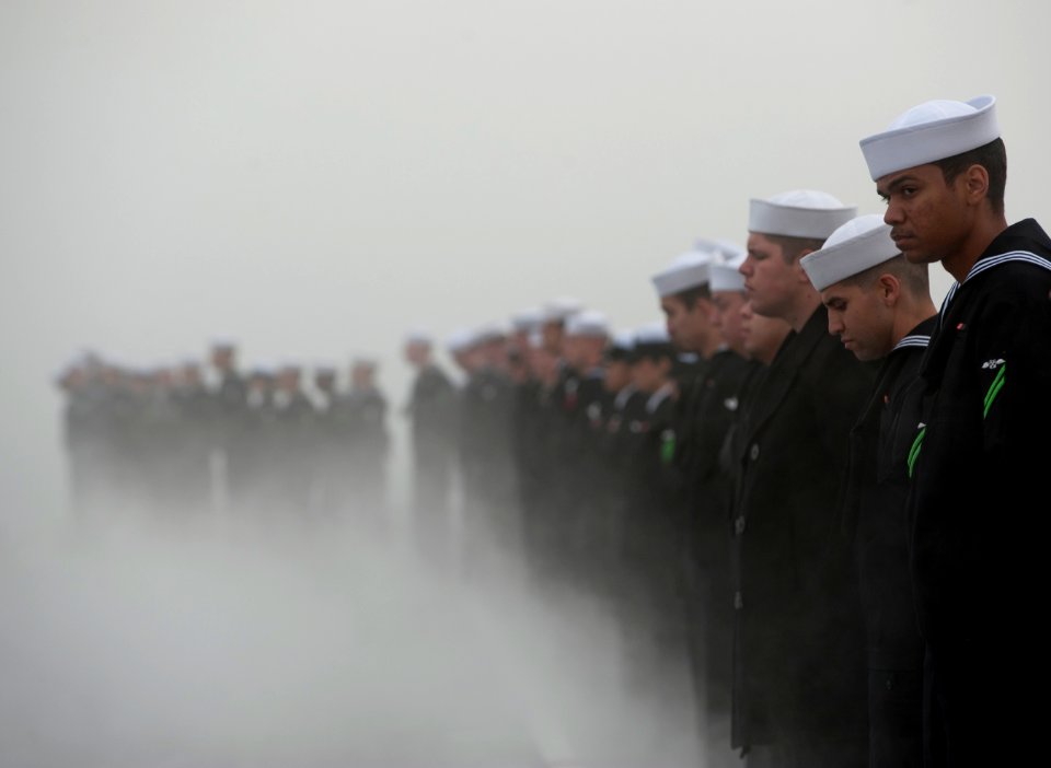 US Navy 111130-N-DR144-654 ailors man the rails as the Nimitz-class aircraft carrier USS Carl Vinson (CVN 70) prepares to depart Naval Air Station