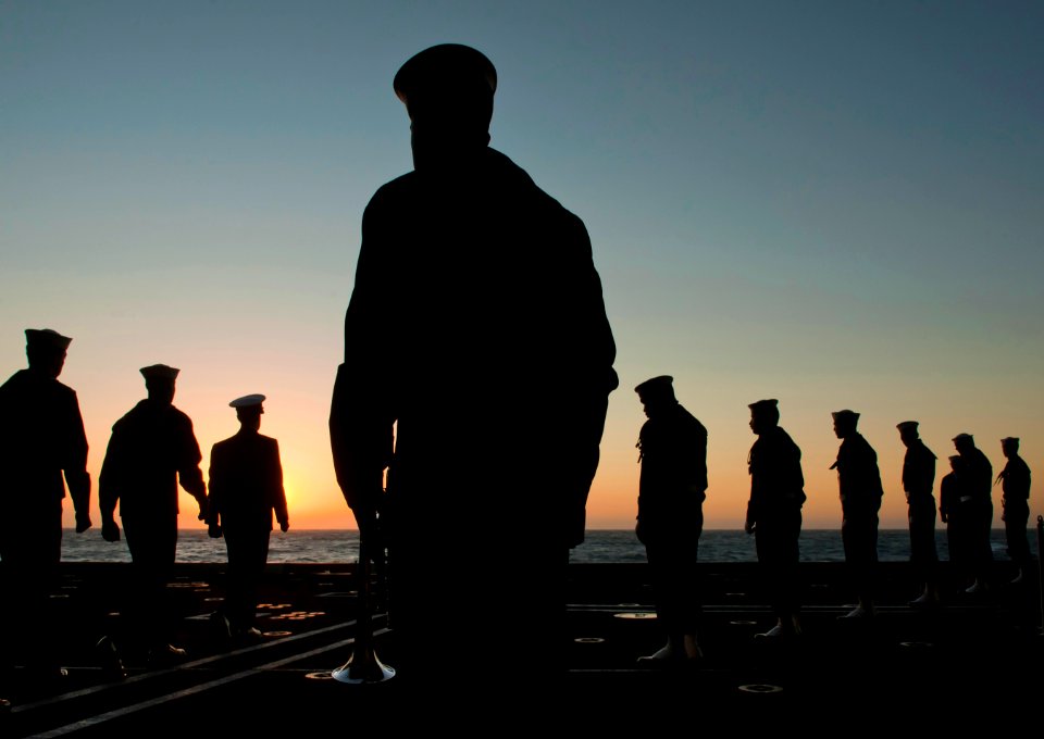 US Navy 111201-N-DR144-110 Sailors assigned to the burial detail arrive on an aircraft elevator to conduct a burial at sea ceremony for 20 former s