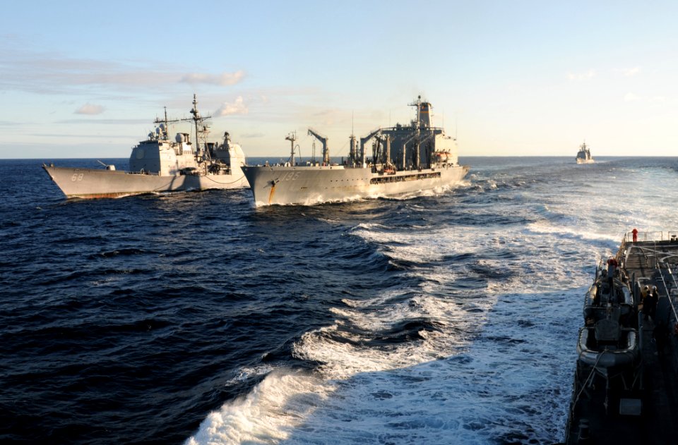 US Navy 111130-N-XQ375-269 The guided-missile cruiser USS Anzio (CG 68), left, conducts a replenishment at sea with the Military Sealift Command fl