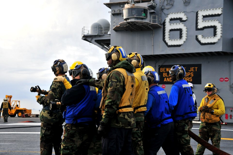 US Navy 111205-N-OP638-011 Sailors aboard the aircraft carrier USS Enterprise (CVN 65) fight a simulated class bravo fire during a flight deck dril