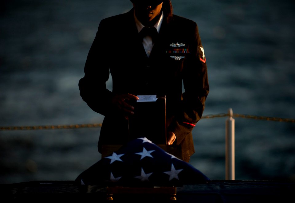 US Navy 111201-N-DR144-332 Hospital Corpsman 3rd Class Lakeshia Atchison prepares cremated remains for committal during a burial at sea ceremony fo