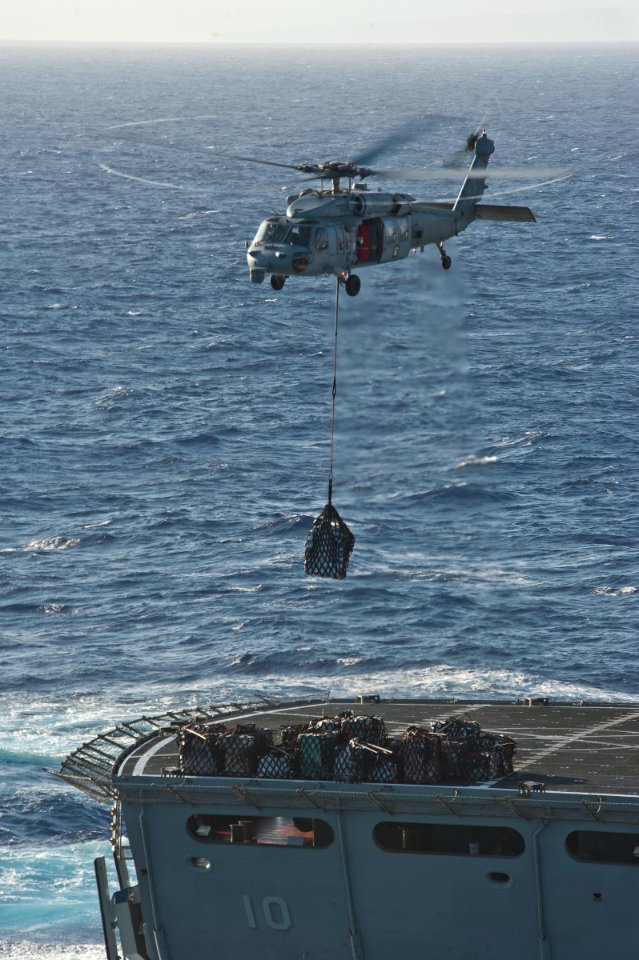 US Navy 111203-N-DX615-142 An MH-60S Sea Hawk helicopter assigned to the Wild Cards of Helicopter Sea Combat Squadron (HSC) 23 transports stores fr