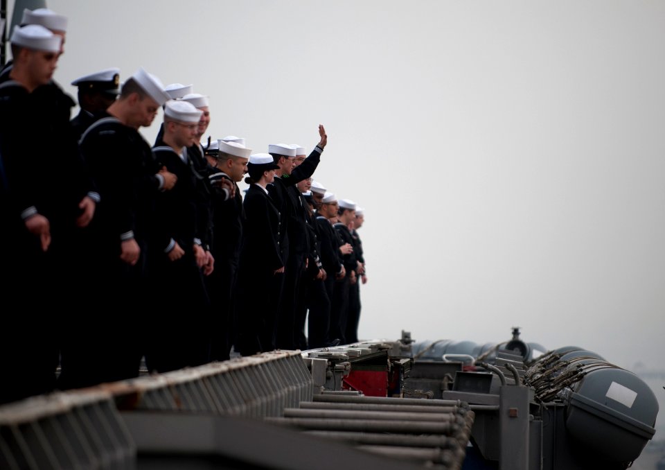 US Navy 111130-N-DR144-584 Sailors wave goodbye to loved ones on the pier while manning the rails as the Nimitz-class aircraft carrier USS Carl Vin